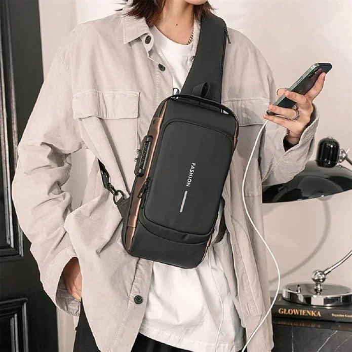 Black leather sling bag with zipper worn crossbody by person holding smartphone