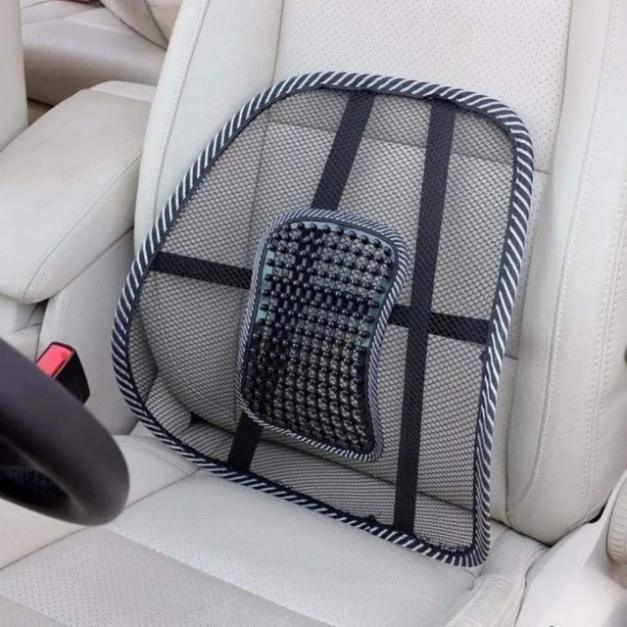 Black mesh car back seat lumbar support cushion with adjustable straps on white leather car seat