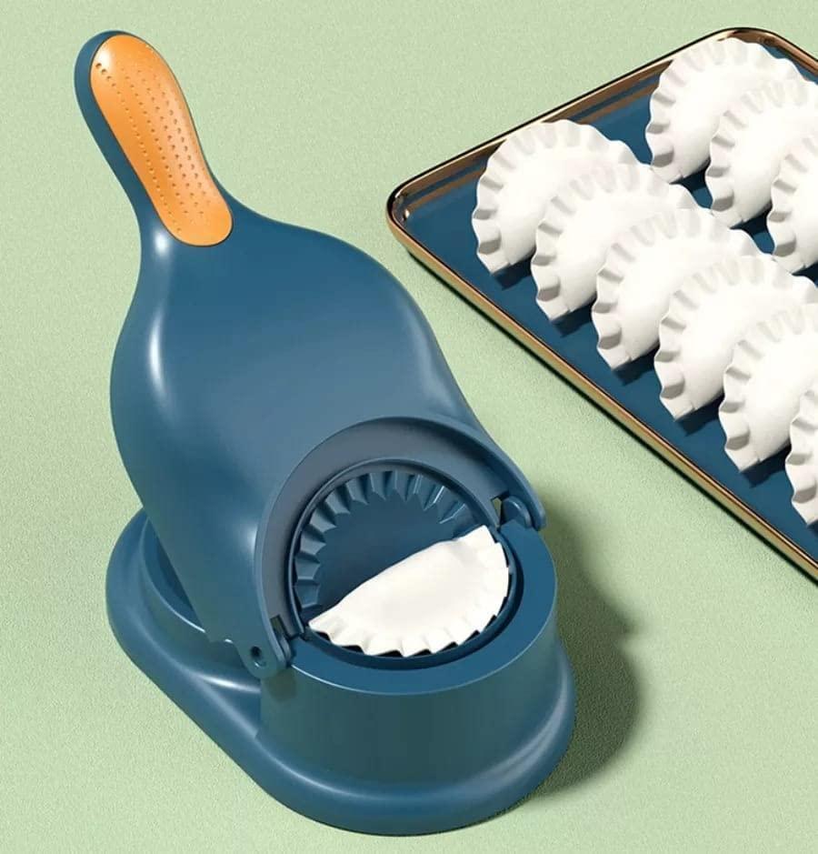 Blue handheld dumpling press with ergonomic handle and formed white dumplings on tray momos gujiya maker