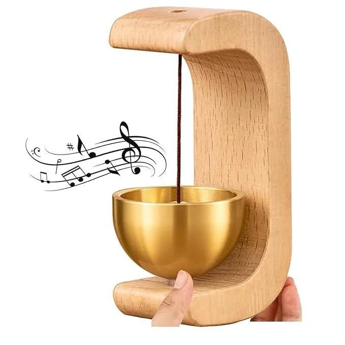 Wooden wind chime with copper bell magnetic door bell held by hand producing musical notes